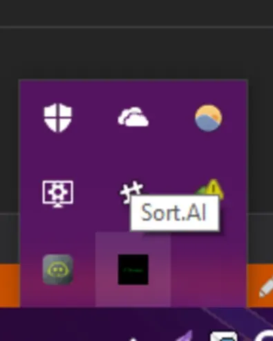 Screenshot of the Windows system tray showing the Sort.AI icon tooltip. The Sort.AI icon appears in the tray with other system icons (e.g., Windows Defender, OneDrive).